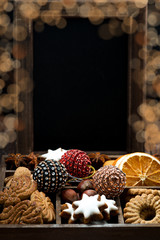 Wall Mural - wooden box with Christmas sweets, spices, dark background