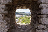 Fototapeta Mapy - Old windmill through small window in fortress wall, Obidos