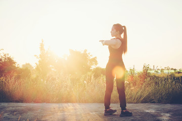  Woman exercise outdoor in Sunset