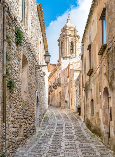 Fotografie, Obraz The narrow street of Erice with the church tower in background, Sicily, Italy