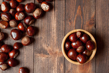 Pile Of Horse Chestnuts On A Bamboo Bowl On Wooden Table