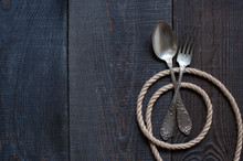 Vintage Cutlery And Rope On The Wooden Table
