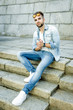 © smmartynenko - Handsome bearded man wearing jeans shirt, portrait shot in urban area