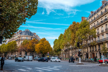 Wall Mural - Streets of Paris, France. Blue sky, buildings and traffic. Shot in late autumn daylight.