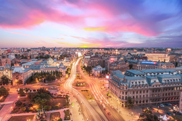 Canvas Print - Aerial view of capital city Bucharest, Romania. University Square at sunset with traffic lights.