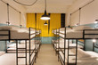Interior design of a dorm room of tourist hostel with clean beds for twelve people