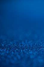 Abstract Dark Blue Glitter Bokeh Holiday Background. Winter Xmas Holidays. Christmas.