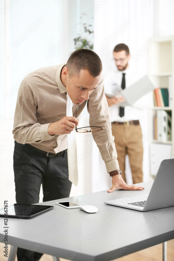 Businessman looking at laptop in office