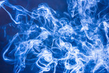 Fototapeta Abstrakcje - Artistic blue smoke on black background texture.