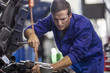© Westend61 - Car mechanic in a workshop repairing car
