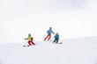 © Westend61 - Father and two sons skiing together