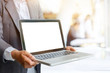 © bongkarn - Business man showing blank screen on a laptop. for Presentation Concept.