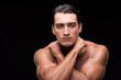 © Elnur - Ripped muscular handsome man on black background