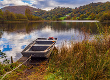 Flat Bottomed Rowing Boat On Lake Grasmere In Autumn, Cumbria, UK