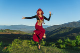 Fototapeta  - young woman dancing georgian national clothes mountains outdoors summer sunny
