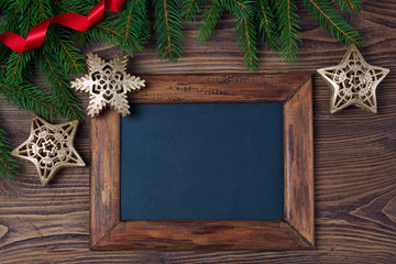 Wall Mural - Merry Christmas decorations, empty chalkboard and frame made of red ribbon, fir, snowflake and stars on a timber background