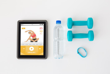 tablet pc, dumbbells, fitness tracker and bottle