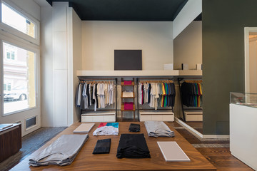 Interior of modern urban fashion clothes t-shirt store