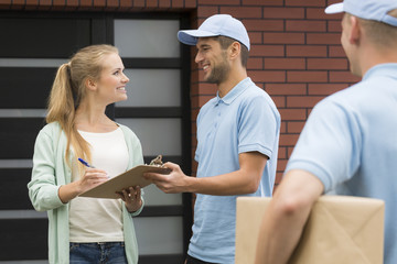 Wall Mural - Courier delivering package to woman