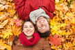 © Syda Productions - close up of smiling couple lying on autumn leaves
