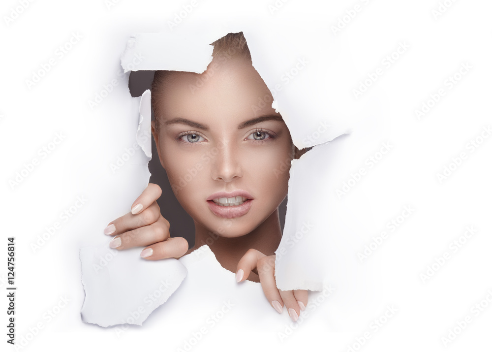 woman with emotions viewing through a hole in paper - obrazy, fototapety, plakaty 