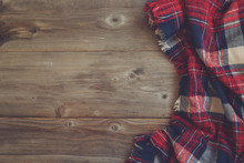 Flat Lay View Of Tartan Textured Scarf On Wooden Background With
