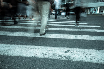 Crosswalk and pedestrian at modern city zebra crossing street. Blur abstract.