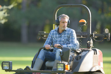 Man driving professional mower