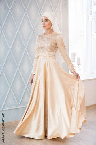 Portrait Of A Beautiful Muslim Bride In Gold Wedding Dress With Portrait Of A Beautiful Muslim Bride In Gold Wedding Dress With White Headdress