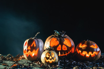 Wall Mural - Halloween pumpkins at wood background.