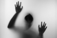 Horror Woman Behind The Matte Glass In Black And White. Blurry H