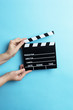© Myvisuals - movie clapper on blue background, cinema concept