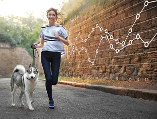 Canvas Print - Young woman jogging with dog. Graphic of training results. Health care and sport concept.