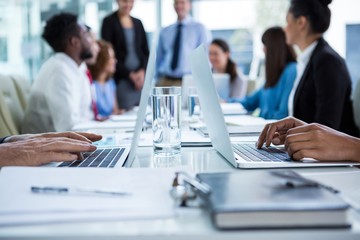 Businesspeople working on laptop