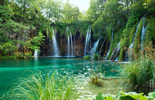 Waterfall And Lake With Transparent Emerald Water