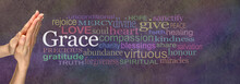 Saying Grace Prayer Hands - Female Hands In Prayer Position With The Word GRACE In White Surrounded By A Wide Multicolored Word Cloud On A Rustic Dark Stone Effect Background
