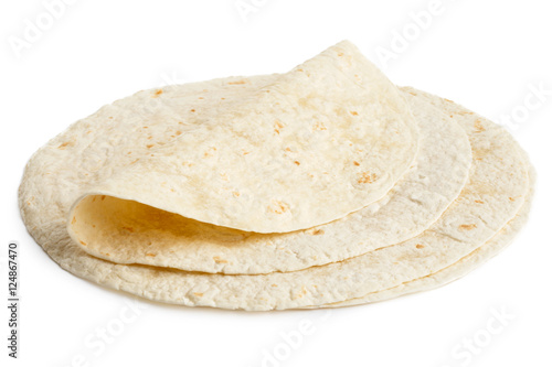 Cuadros en Lienzo Stack of tortilla wraps and one folded wrap isolated on white.