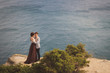 © anna_gorbenko - Romantic and stylish caucasian couple standing on the background of spectacular sea view. Love, relationships, romance, happiness concept.