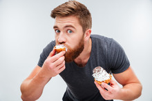 Close Up Portrait Of A Hungry Man Biting Cream Cake