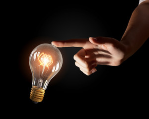 Wall Mural - hand pointing light bulb . mixed media