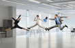 © Sergey Nivens - Dancing businesspeople in office room . Mixed media