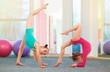 Flexible kids gymnasts doing acrobatic exercise in gym. Sport concept