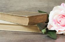 Old Books And Flower Rose On A Wooden Background. Romantic Floral Frame Background. Picture Of A Flowers Lying On An Antique Book. Flowers On Vintage Wood Background With Romantic Vintage Background.