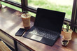 © nomadnes - Computer laptop in coffee shop,Business work accessories.