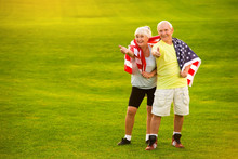 Senior Couple Holding USA Flag. Elderly People Show Thumb Up. Healthy Citizens Of Strong Country. Proud To Be American.