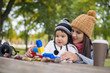 © tutye - mother with her child play in park playing with blocks