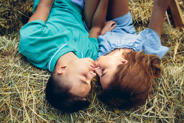 Wall Mural - man and woman lie on hay