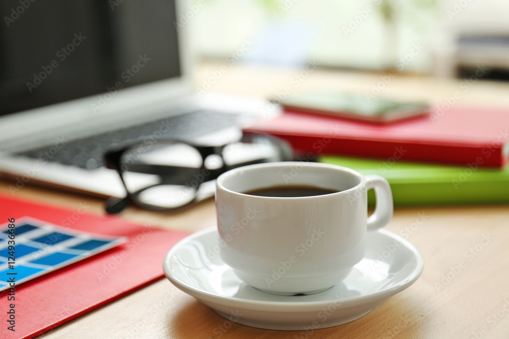 Cup of coffee on office table, close up