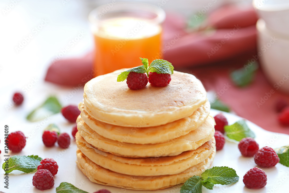 Tasty pancakes with berries on white table