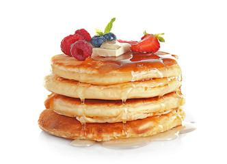 Wall Mural - Stack of tasty pancakes with berries and syrup isolated on white